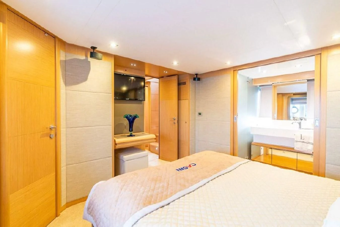 a bedroom with a bed and a desk aboard FERRETTI Yacht for Sale