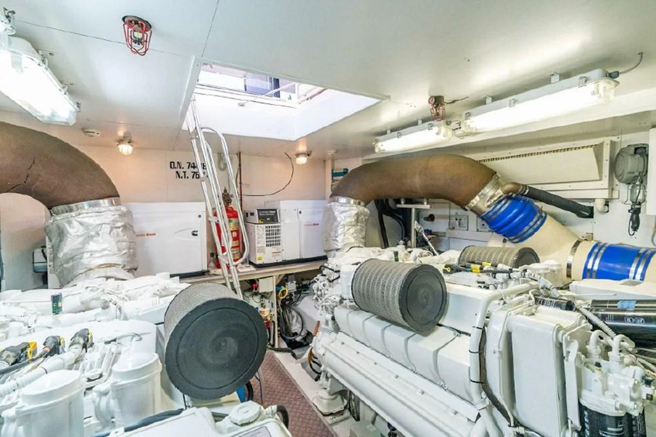 a person's hand holding a tool in a room with equipment and other objects aboard FERRETTI Yacht for Sale