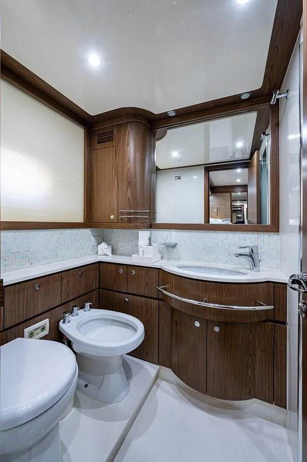 a bathroom with a toilet and a sink aboard FERRETTI Yacht for Sale