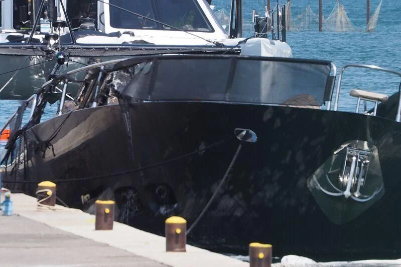 a black boat on a dock aboard BLACK DIAMOND Yacht for Sale