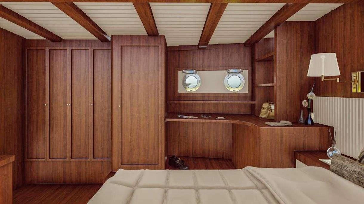 a room with a bed and a desk aboard QUEEN OF DATCA Yacht for Charter