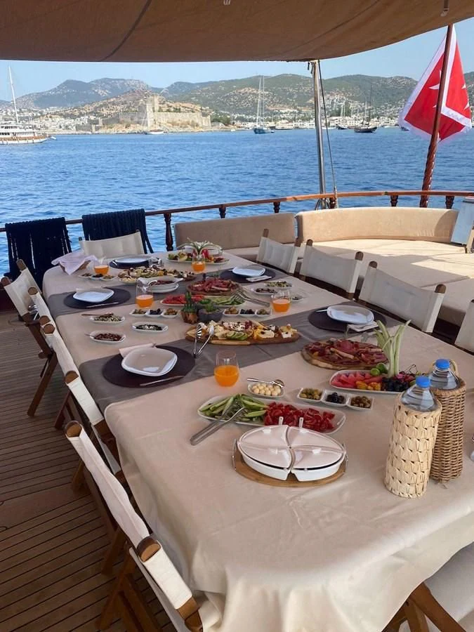 a table with food on it aboard QUEEN OF DATCA Yacht for Charter
