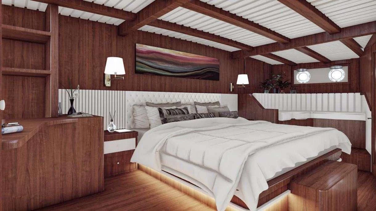 a room with a bed and a wood wall aboard QUEEN OF DATCA Yacht for Charter