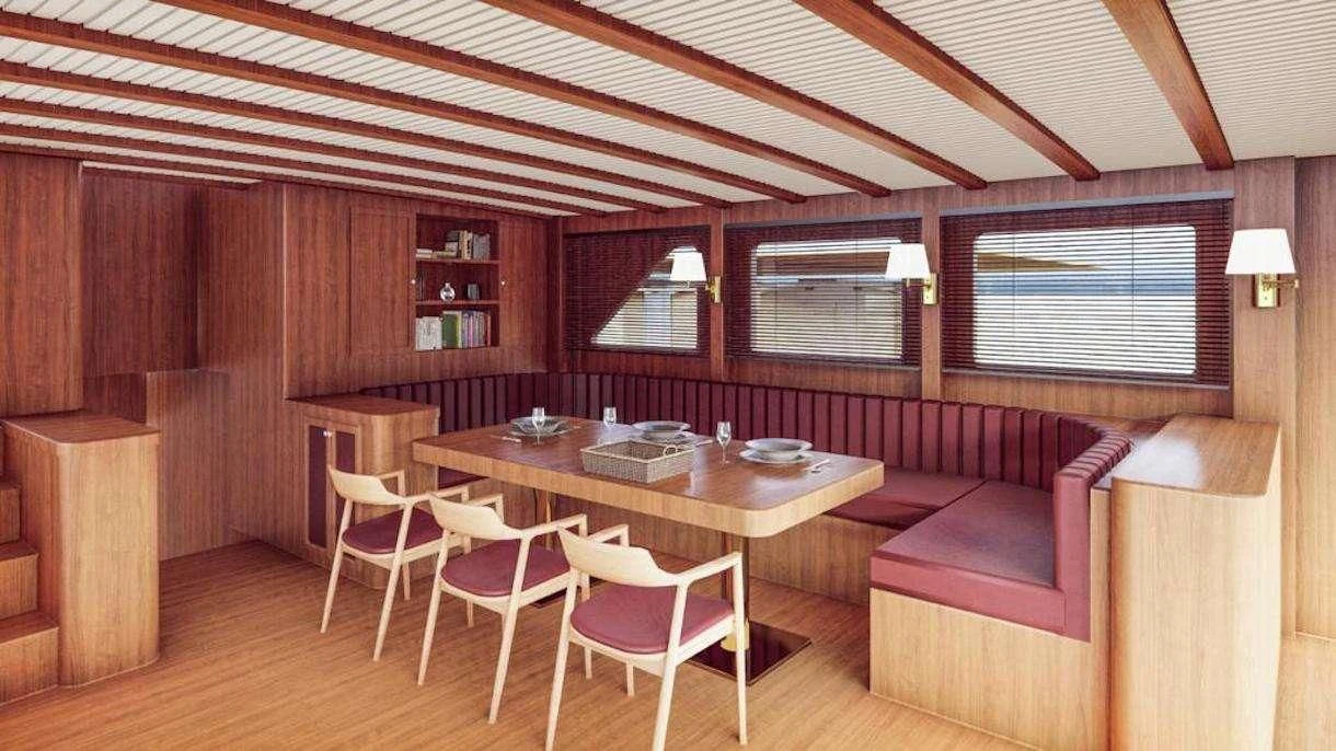 a room with a table and chairs aboard QUEEN OF DATCA Yacht for Charter