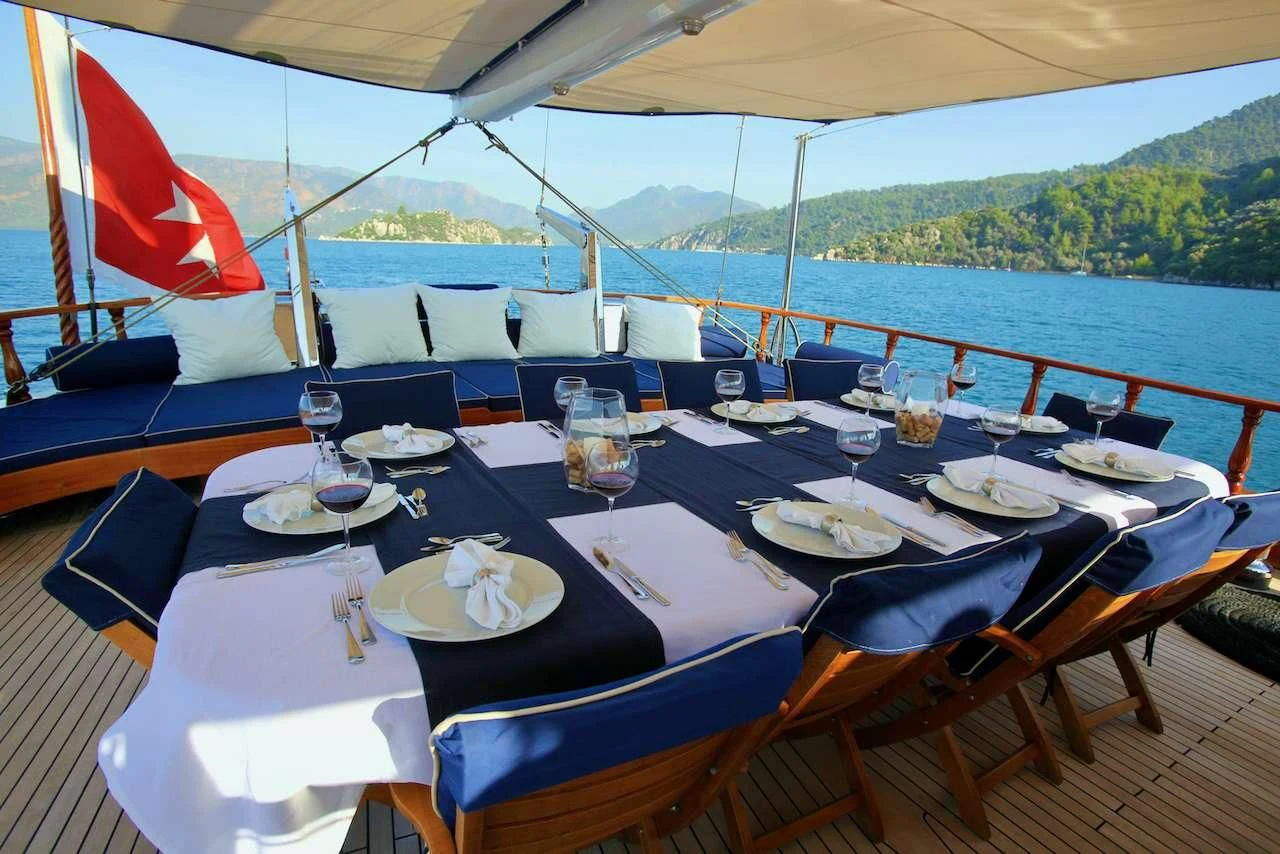 a table set with place settings aboard QUEEN OF DATCA Yacht for Charter