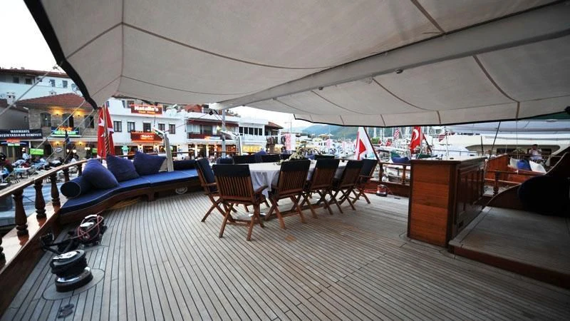 a patio with a table and chairs aboard QUEEN OF DATCA Yacht for Charter