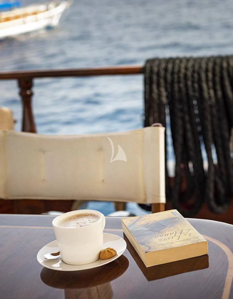 a cup of coffee on a table aboard QUEEN OF DATCA Yacht for Charter