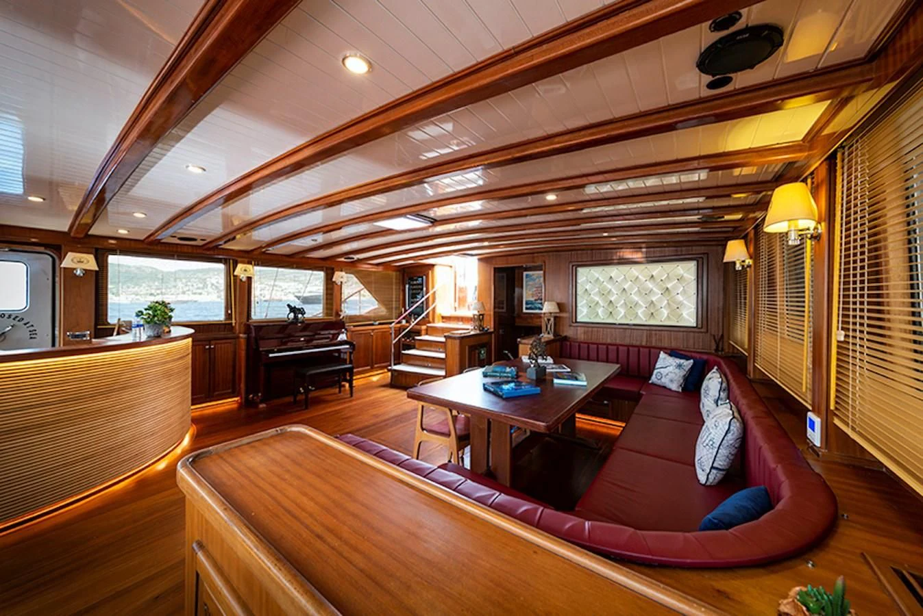 a living room with a couch and a piano aboard QUEEN OF DATCA Yacht for Charter