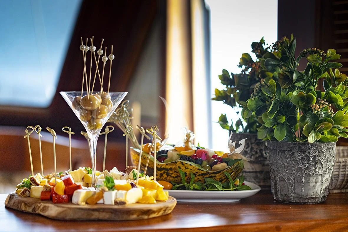 a table with food and a glass of wine aboard QUEEN OF DATCA Yacht for Charter