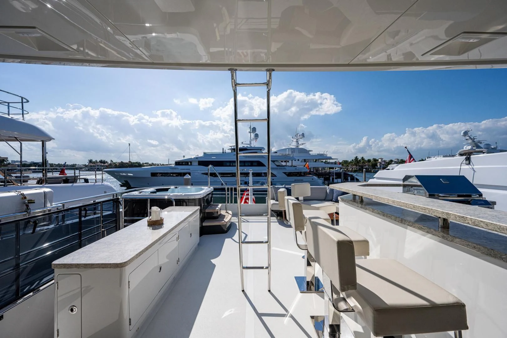 a deck with boats and a large building with a blue sky aboard SEASUITE Yacht for Charter