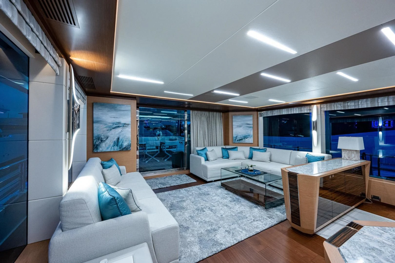 a living room with a couch and a coffee table aboard SEASUITE Yacht for Charter