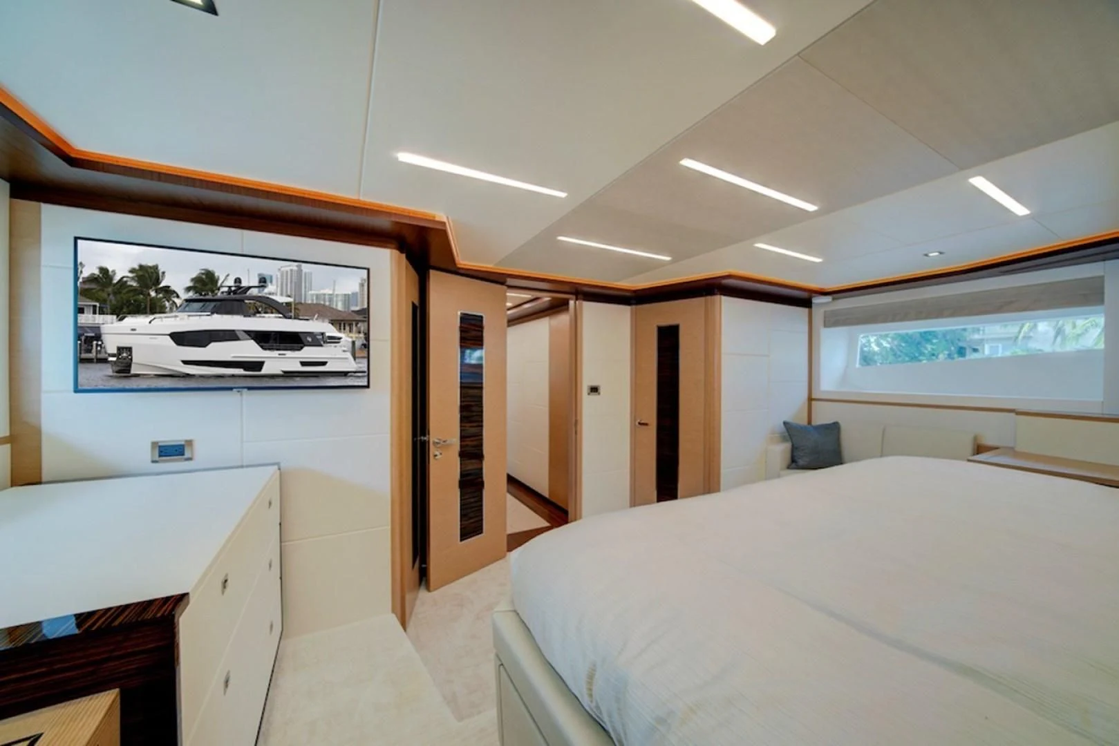 a room with a bed and a desk aboard SEASUITE Yacht for Charter