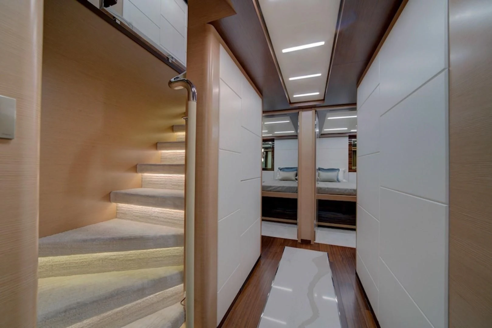 a hallway with a door and a bed aboard SEASUITE Yacht for Charter