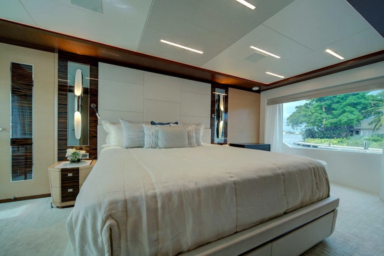 a bed with a white sheet aboard SEASUITE Yacht for Charter