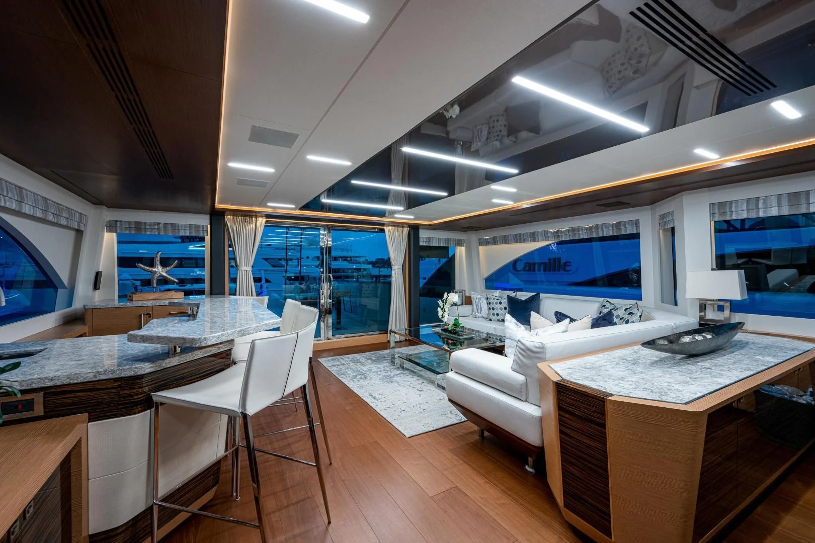 a room with a table chairs and a large window aboard SEASUITE Yacht for Charter