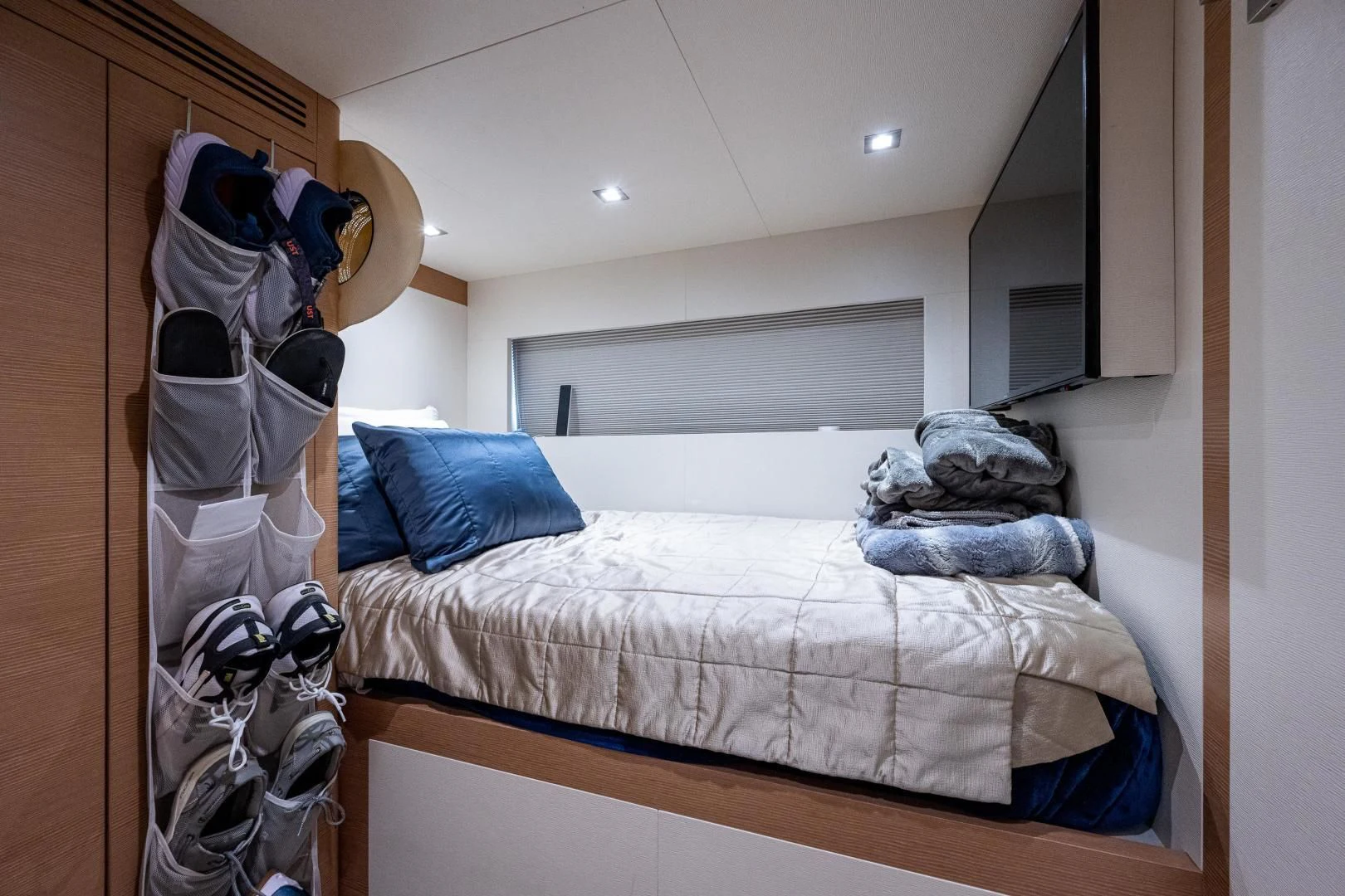 a bed with clothes on it aboard SEASUITE Yacht for Charter