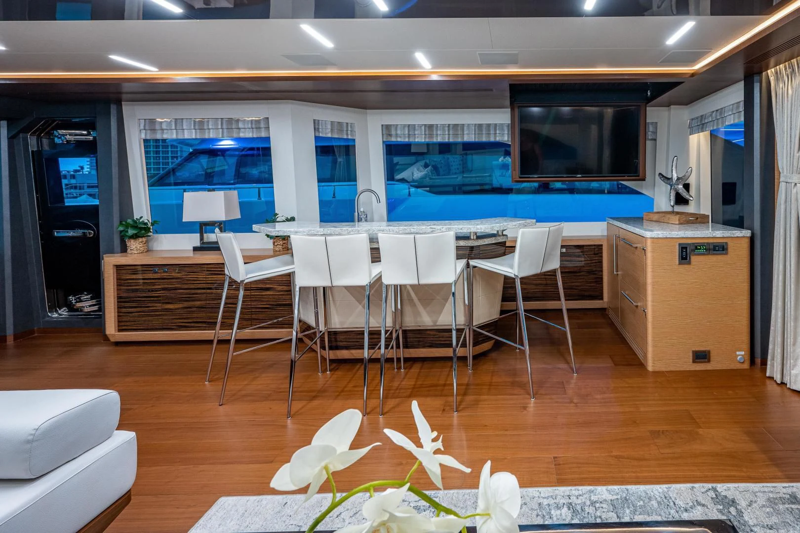 a room with a table and chairs aboard SEASUITE Yacht for Charter