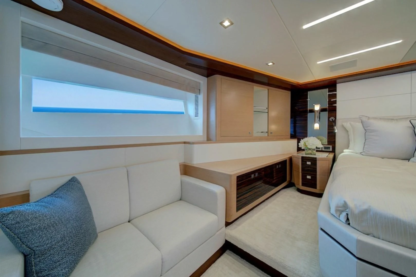 a room with a bed and a couch aboard SEASUITE Yacht for Charter