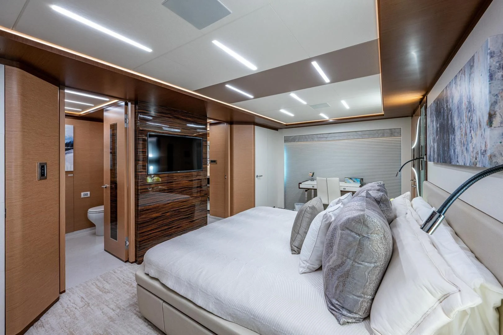 a bedroom with a bed and a wood closet aboard SEASUITE Yacht for Charter