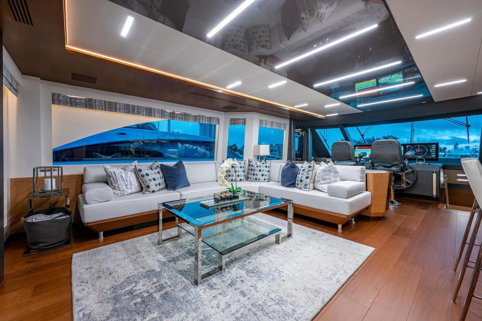 a living room with a large blue screen aboard SEASUITE Yacht for Charter