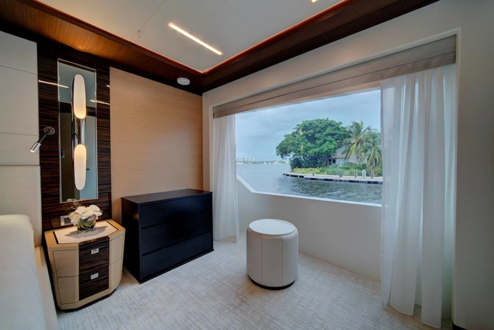 a room with a large window and a view of the ocean aboard SEASUITE Yacht for Charter