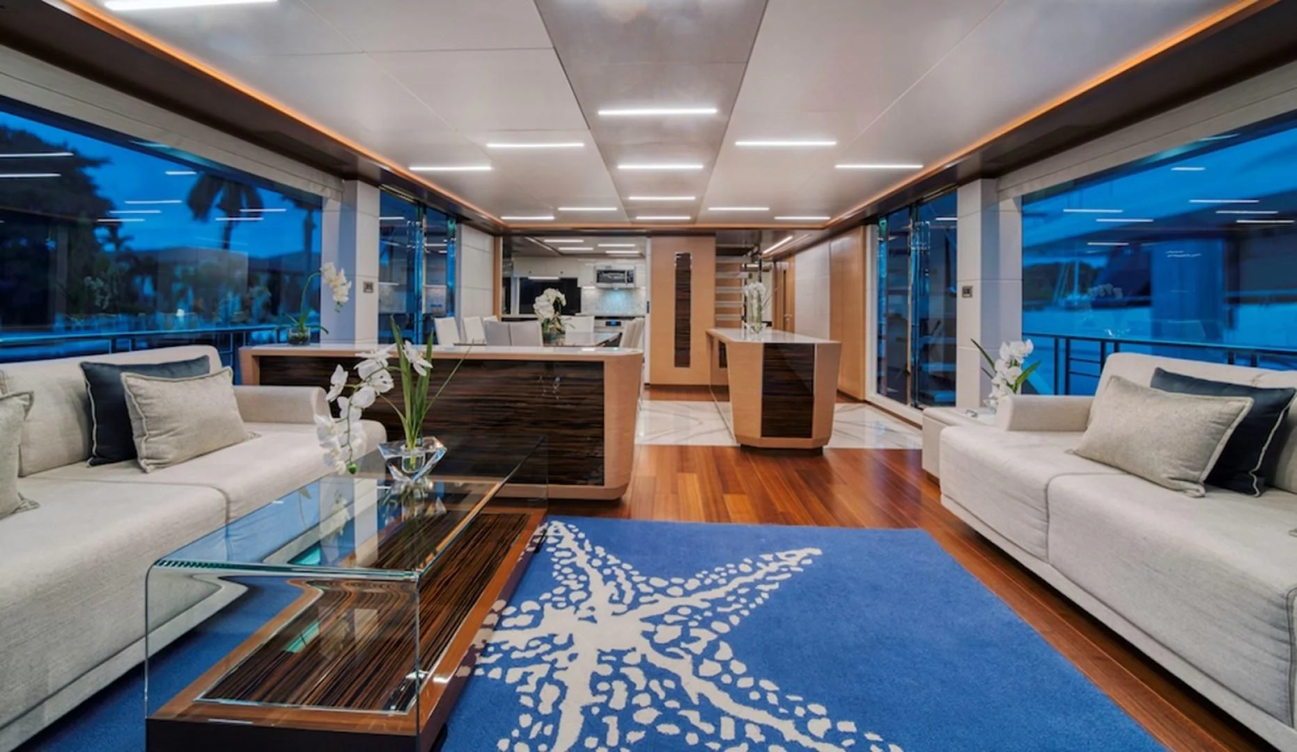 a living room with a blue rug aboard SEASUITE Yacht for Charter
