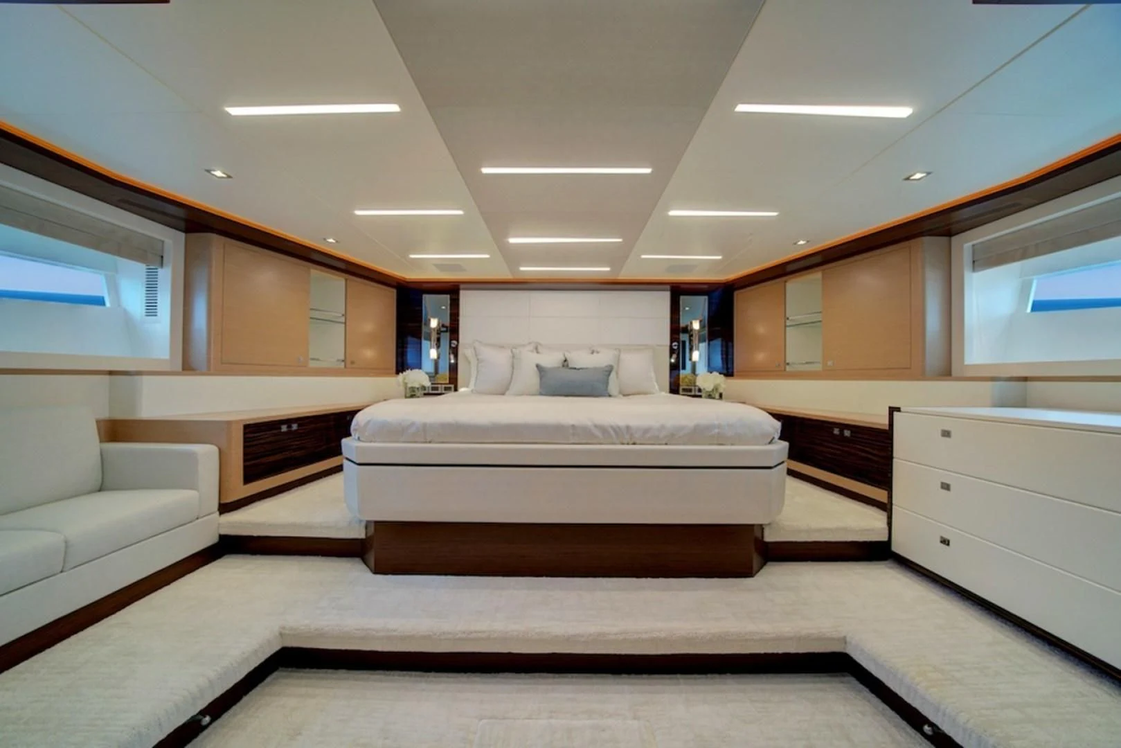 a room with a bed and a couch aboard SEASUITE Yacht for Charter