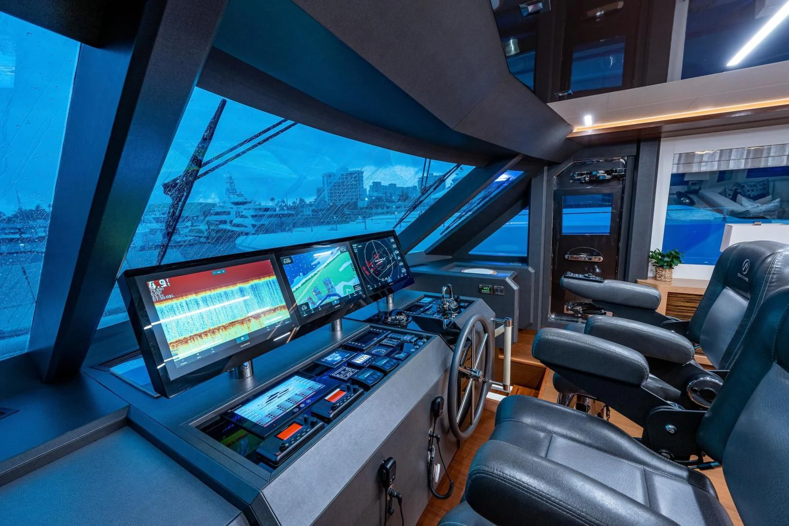 inside of a vehicle with monitors and seats and a view of the city aboard SEASUITE Yacht for Charter