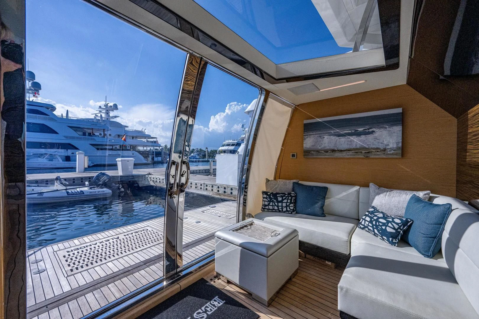 a room with a couch and a view of the water aboard SEASUITE Yacht for Charter