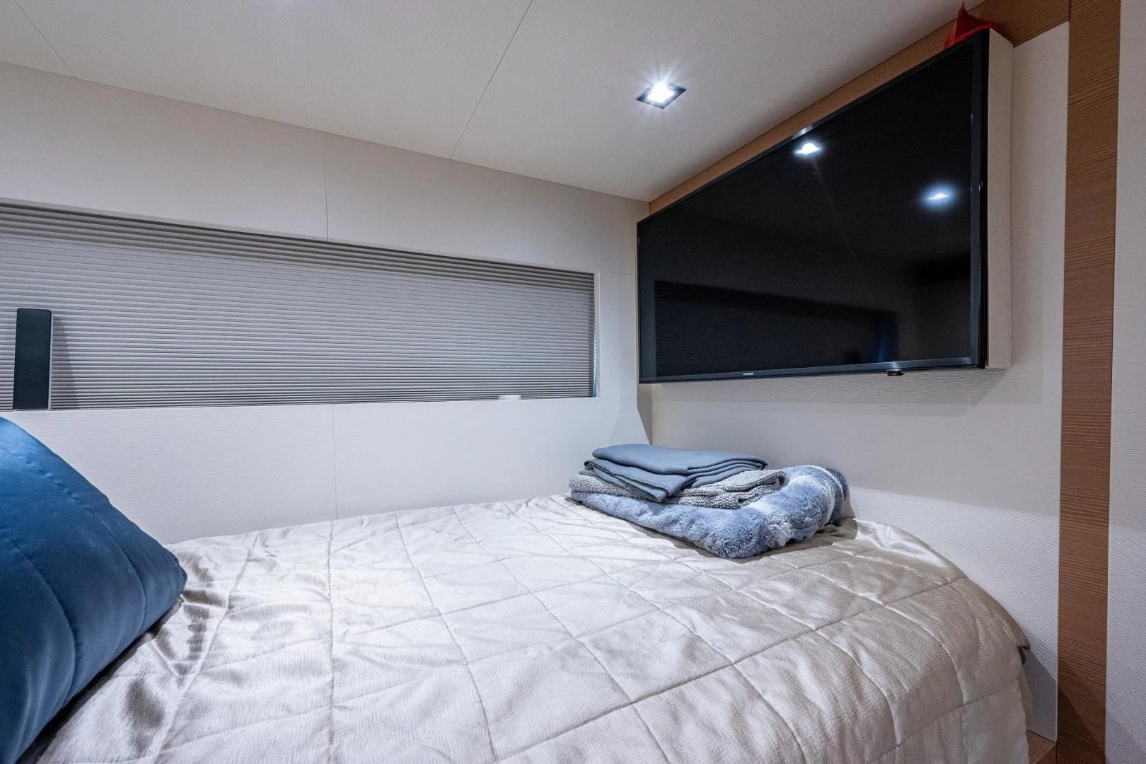 a bed with a white sheet aboard SEASUITE Yacht for Charter