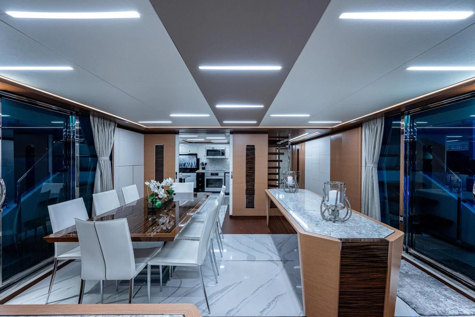 a large room with a table and chairs aboard SEASUITE Yacht for Charter