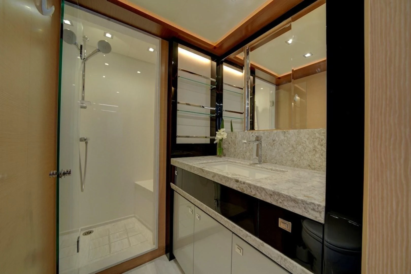 a bathroom with a large mirror aboard SEASUITE Yacht for Charter
