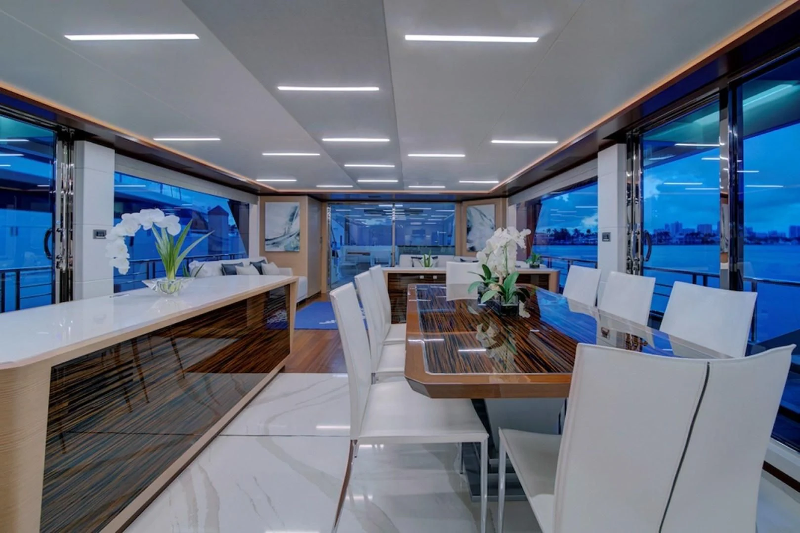 a room with a table chairs and a window aboard SEASUITE Yacht for Charter