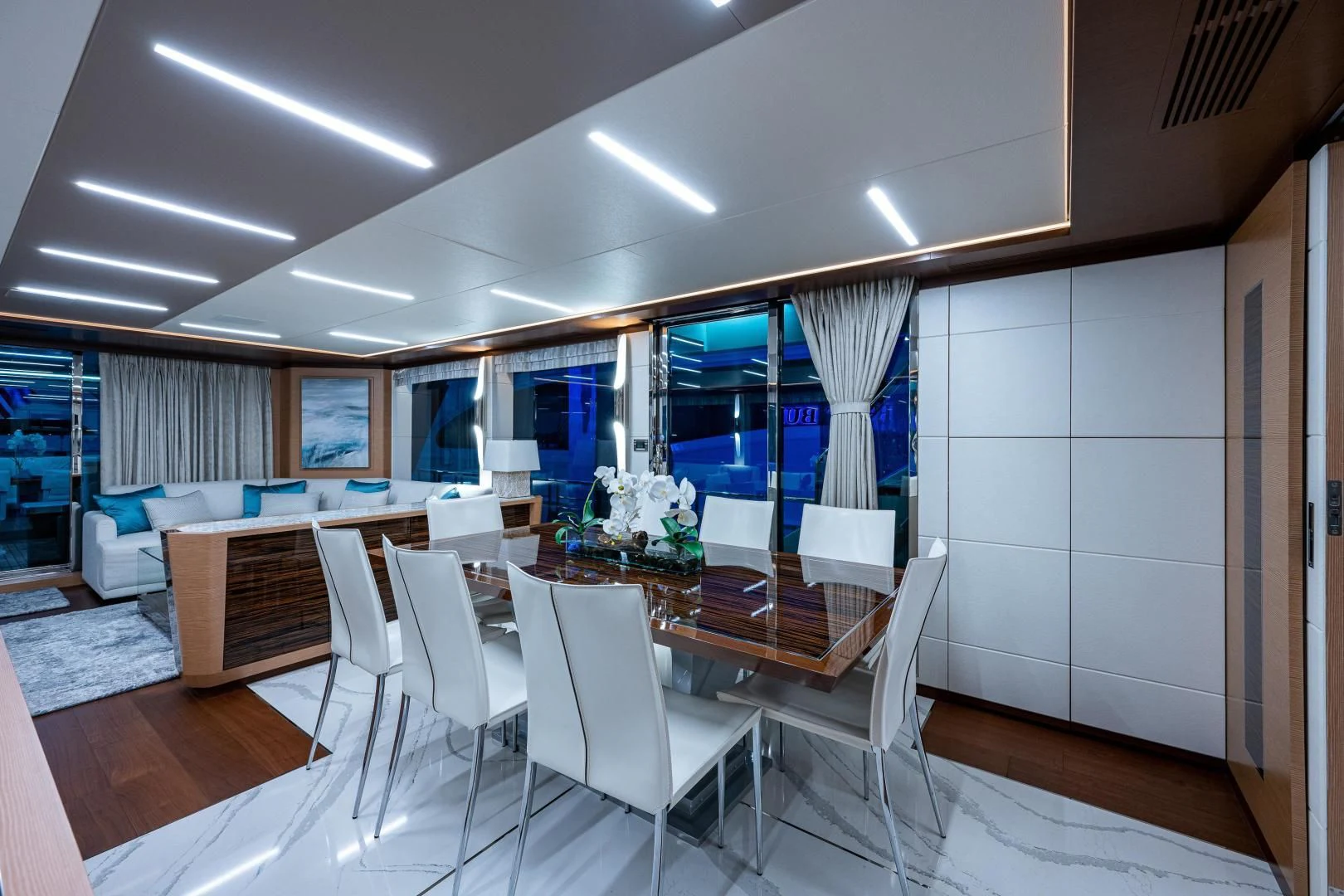 a room with a table chairs and a large window aboard SEASUITE Yacht for Charter