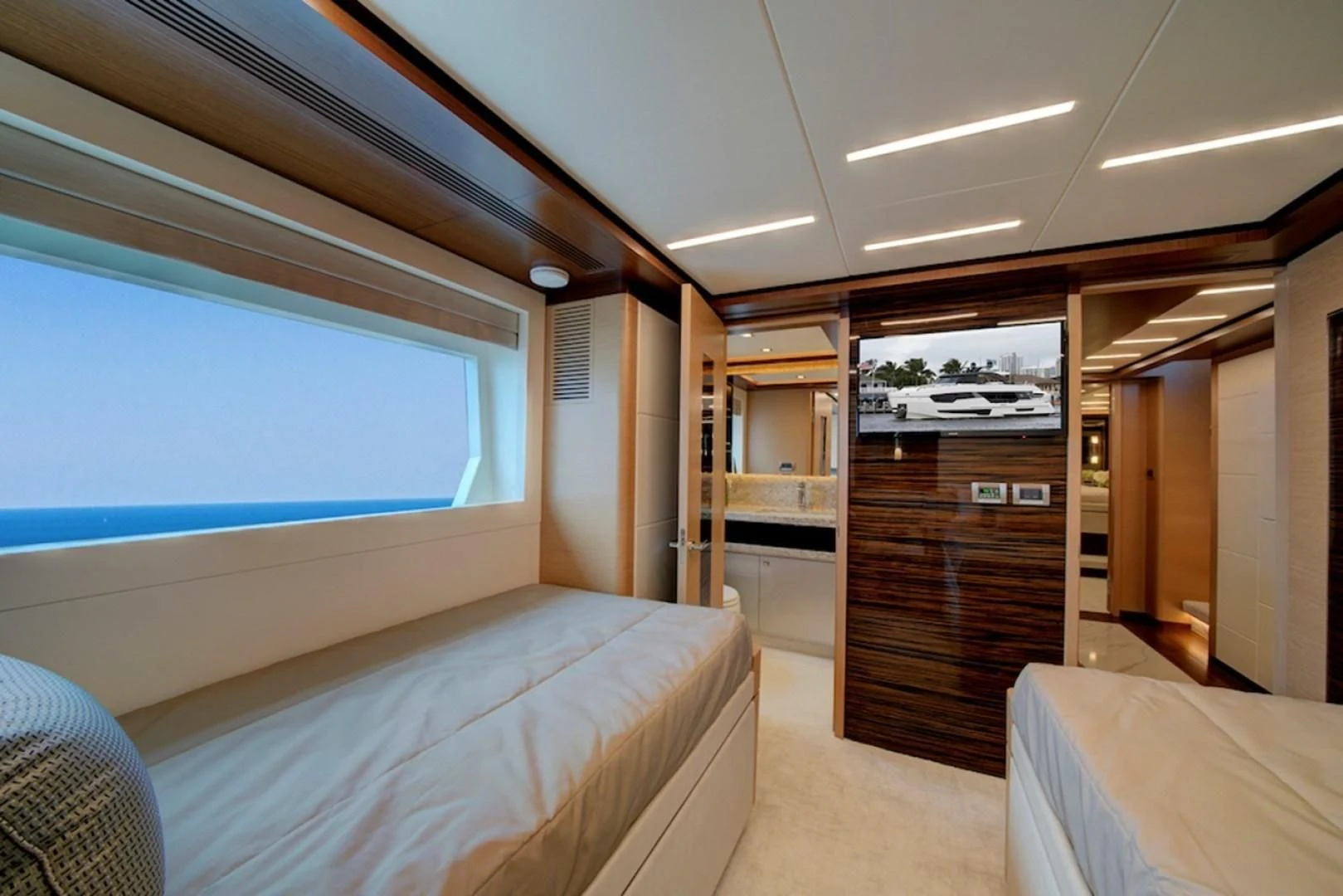 a room with a bed and a door aboard SEASUITE Yacht for Charter