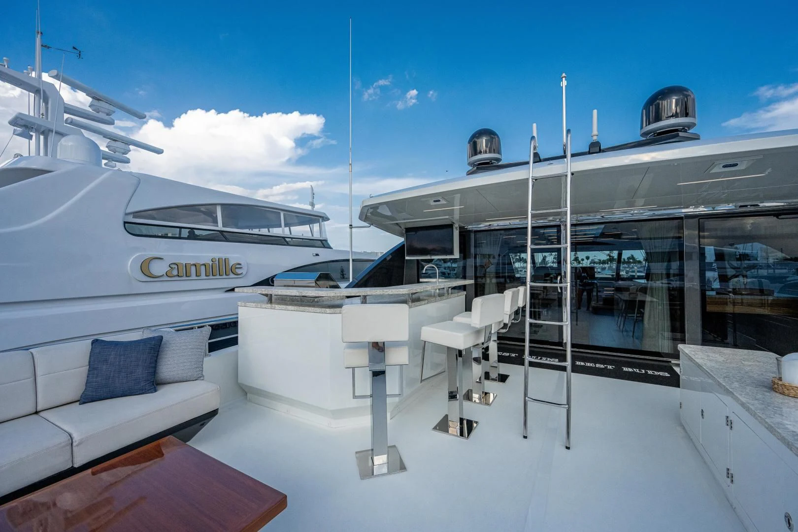 a white boat on a dock aboard SEASUITE Yacht for Charter
