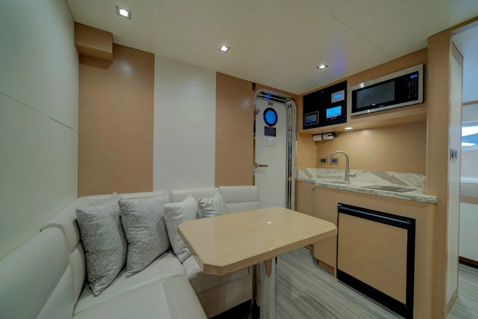 a room with a couch and a table aboard SEASUITE Yacht for Charter