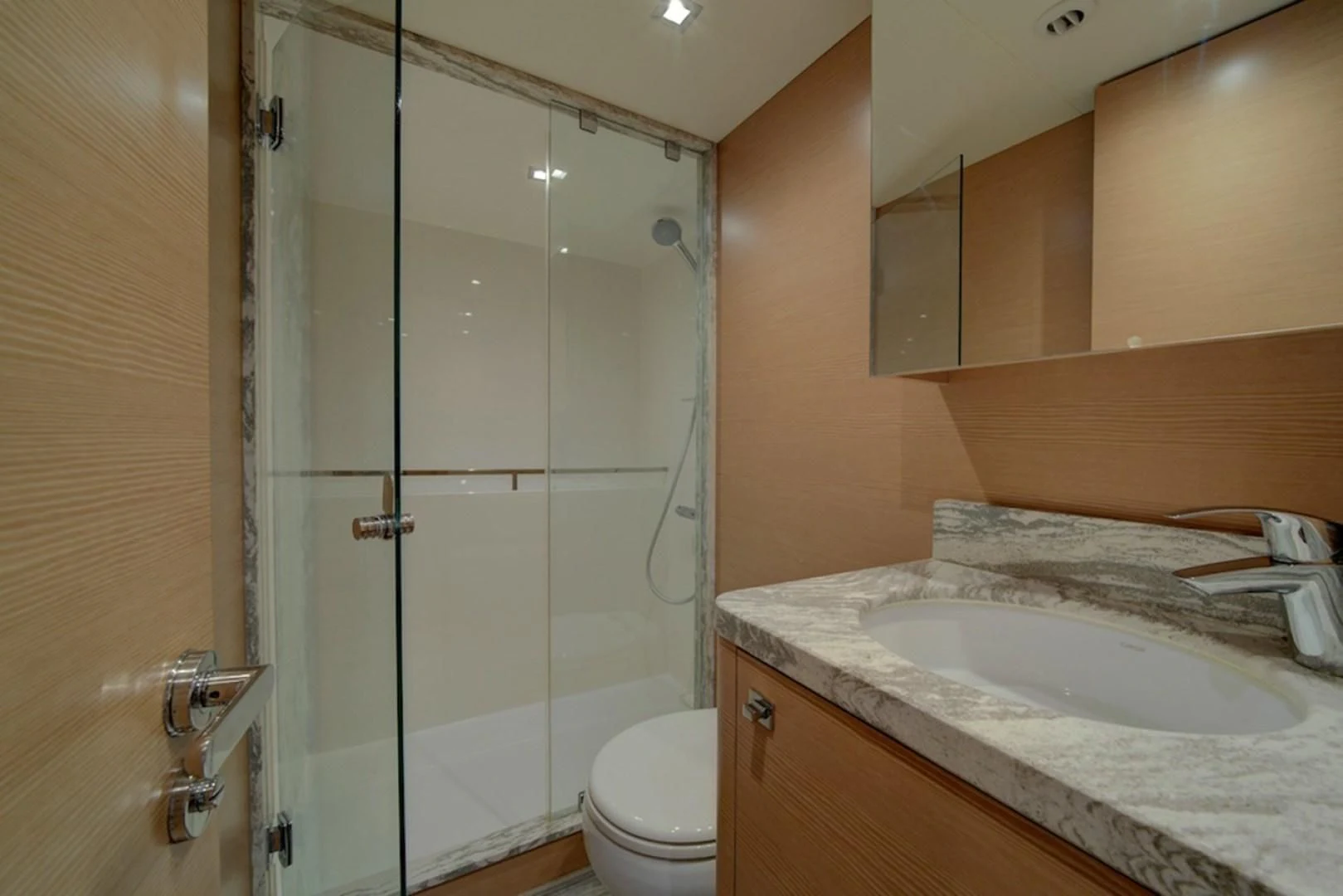 a bathroom with a glass shower aboard SEASUITE Yacht for Charter