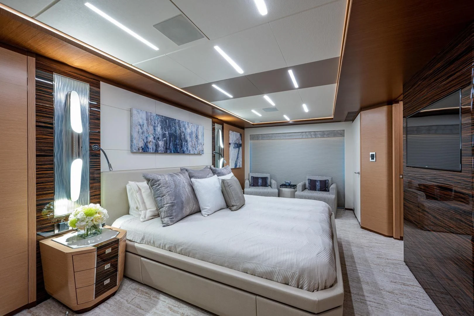 a bedroom with a bed and a desk aboard SEASUITE Yacht for Charter