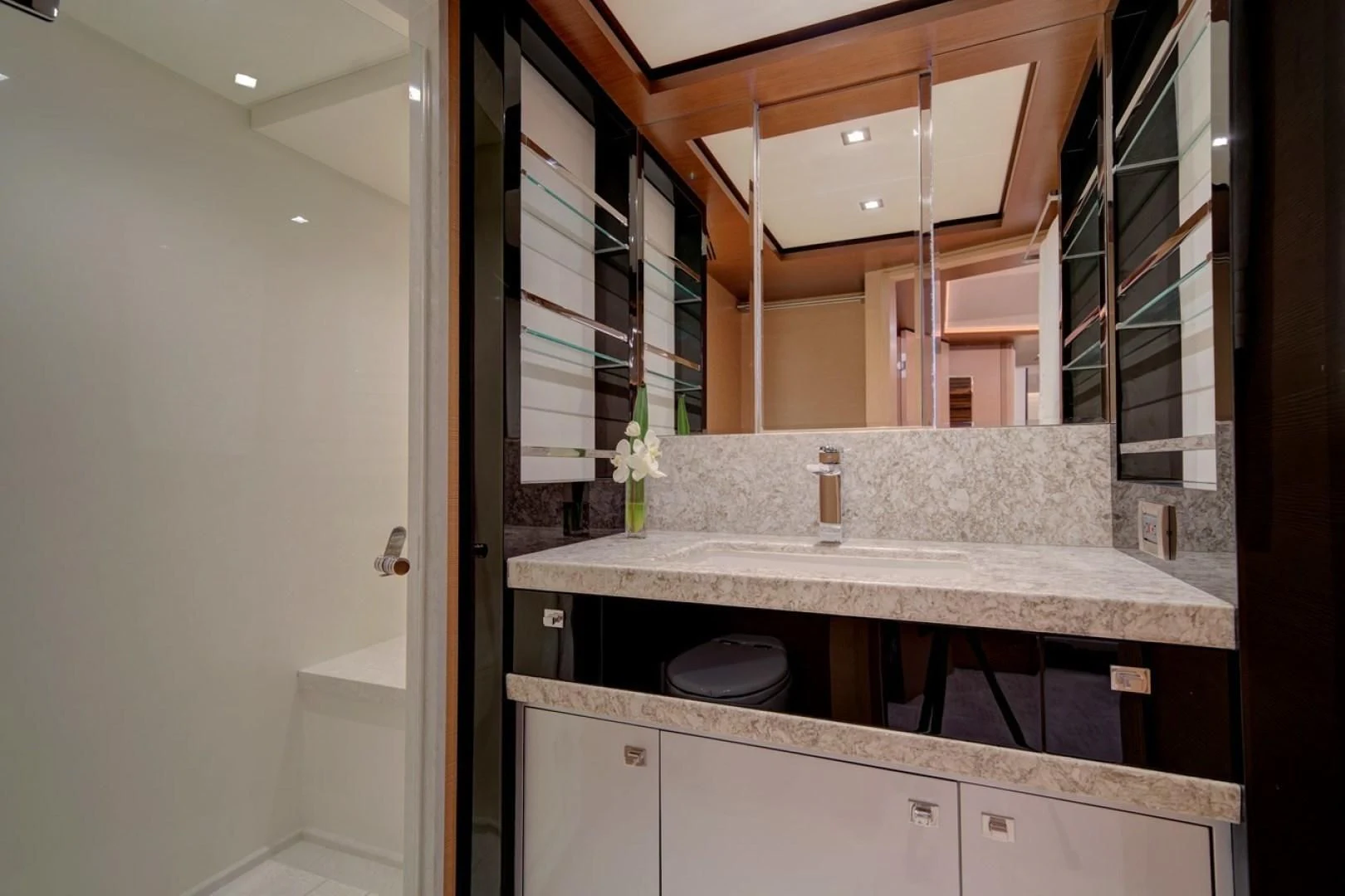 a bathroom with a large mirror aboard SEASUITE Yacht for Charter