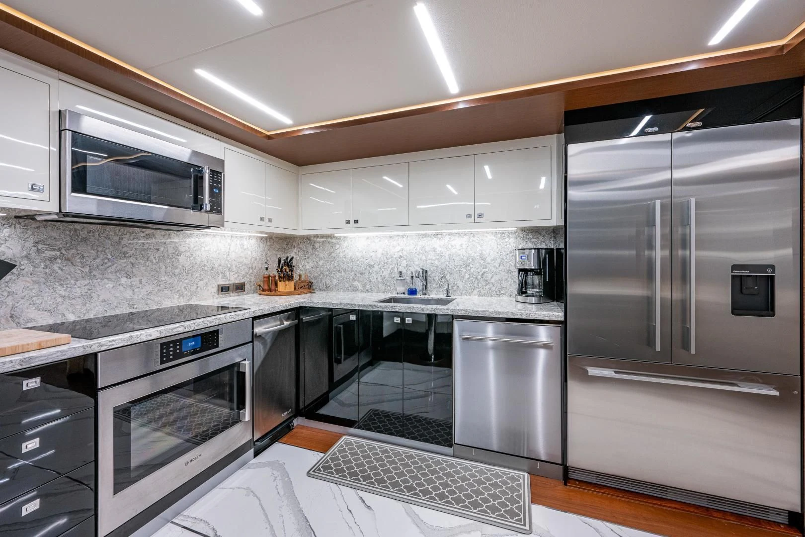 a kitchen with stainless steel appliances aboard SEASUITE Yacht for Charter