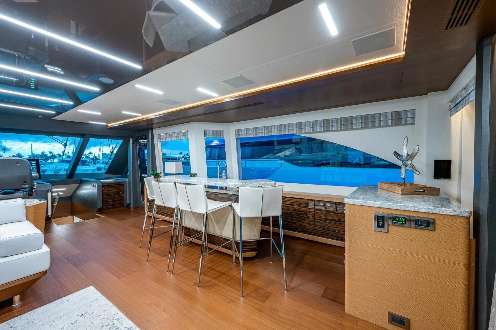 a room with a large pool table and chairs aboard SEASUITE Yacht for Charter