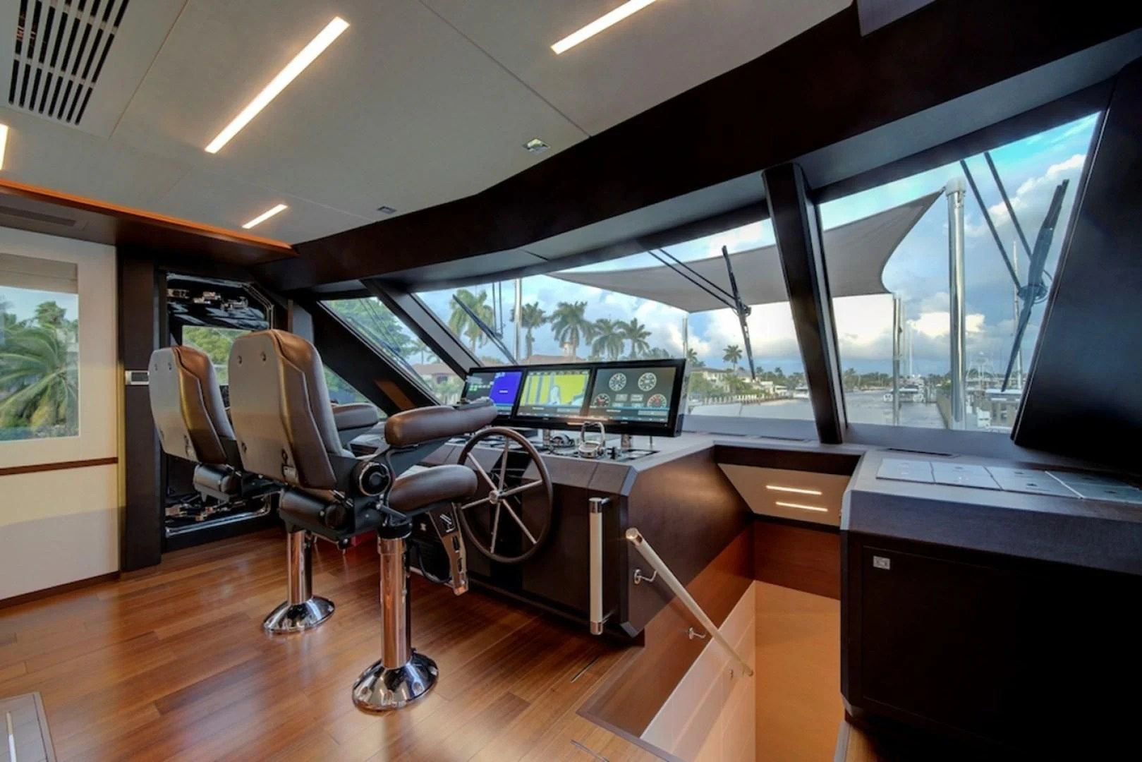 a room with a desk and chairs aboard SEASUITE Yacht for Charter