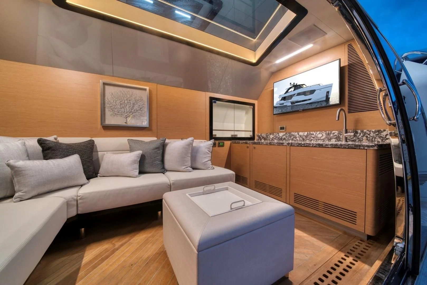 a living room with a couch and a tv aboard SEASUITE Yacht for Charter