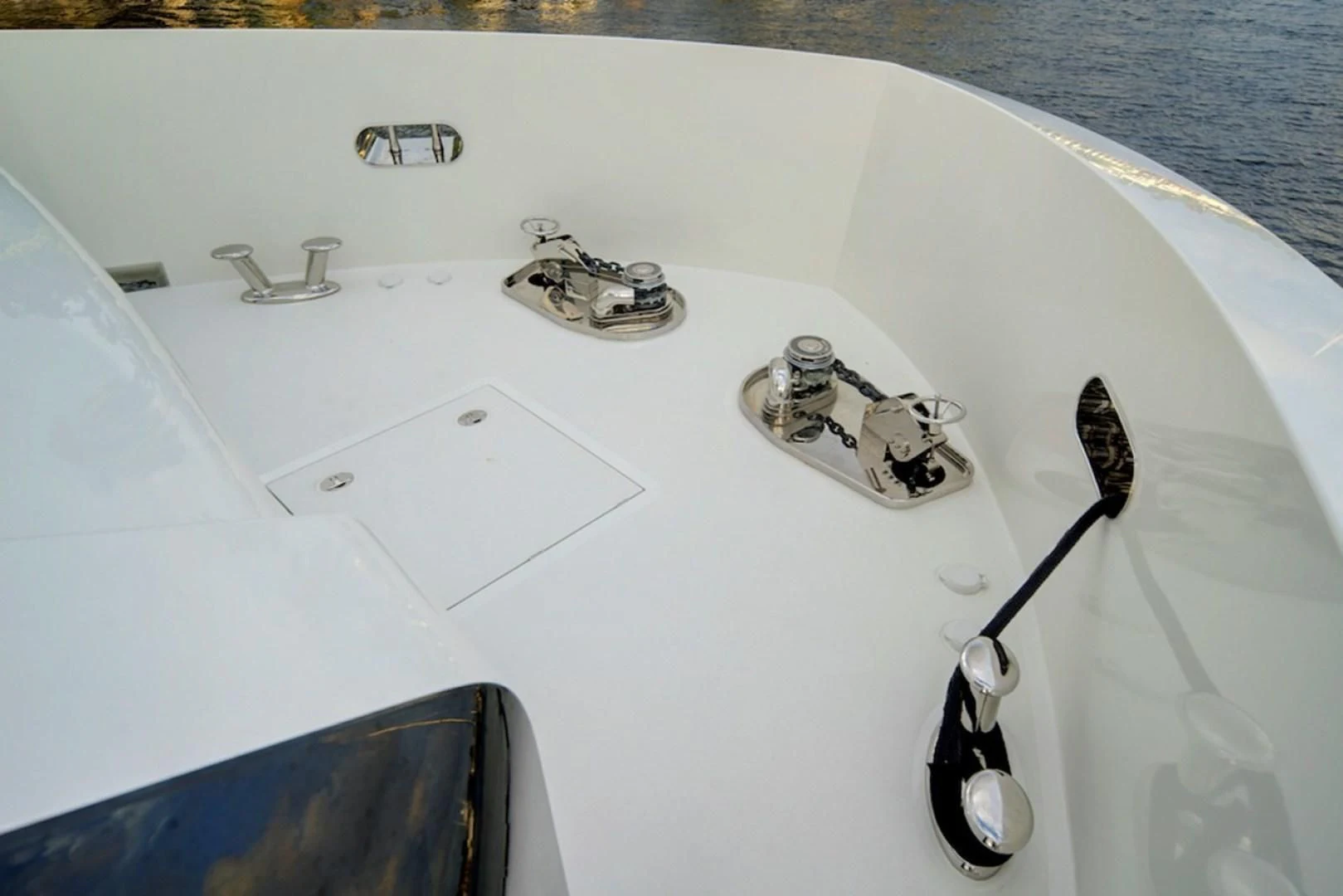 a white sink with a faucet and a couple of spoons aboard SEASUITE Yacht for Charter