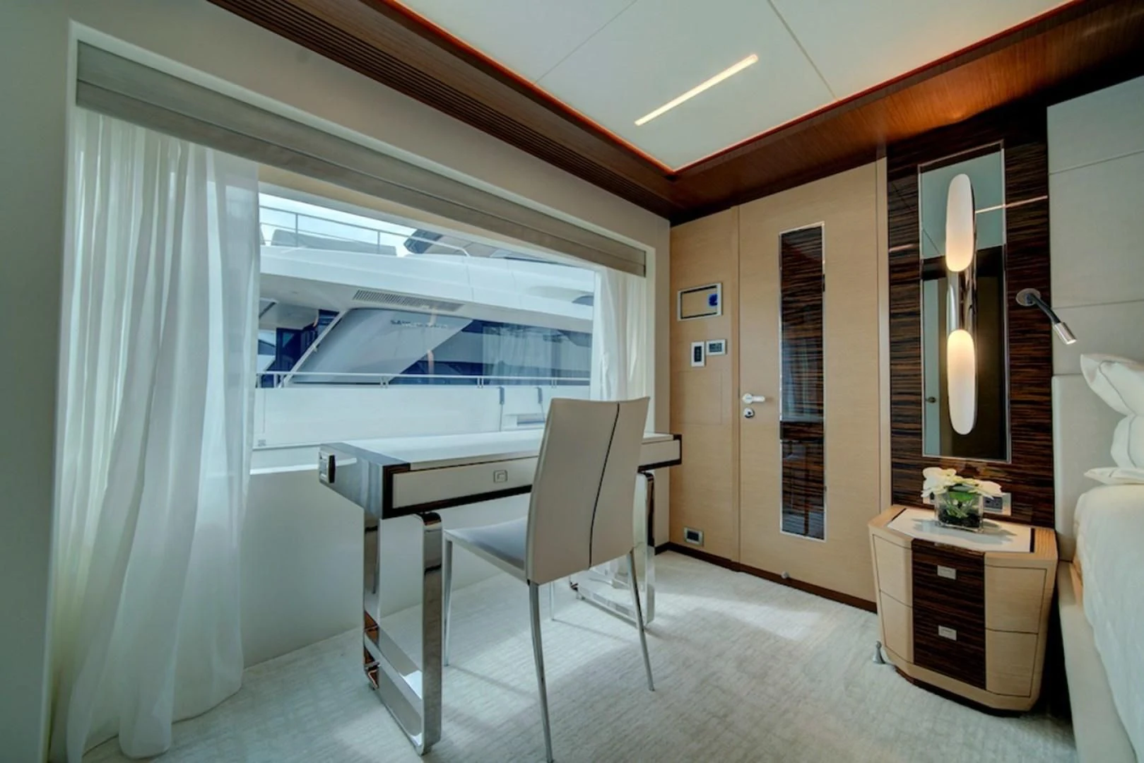 a room with a desk and a chair aboard SEASUITE Yacht for Charter