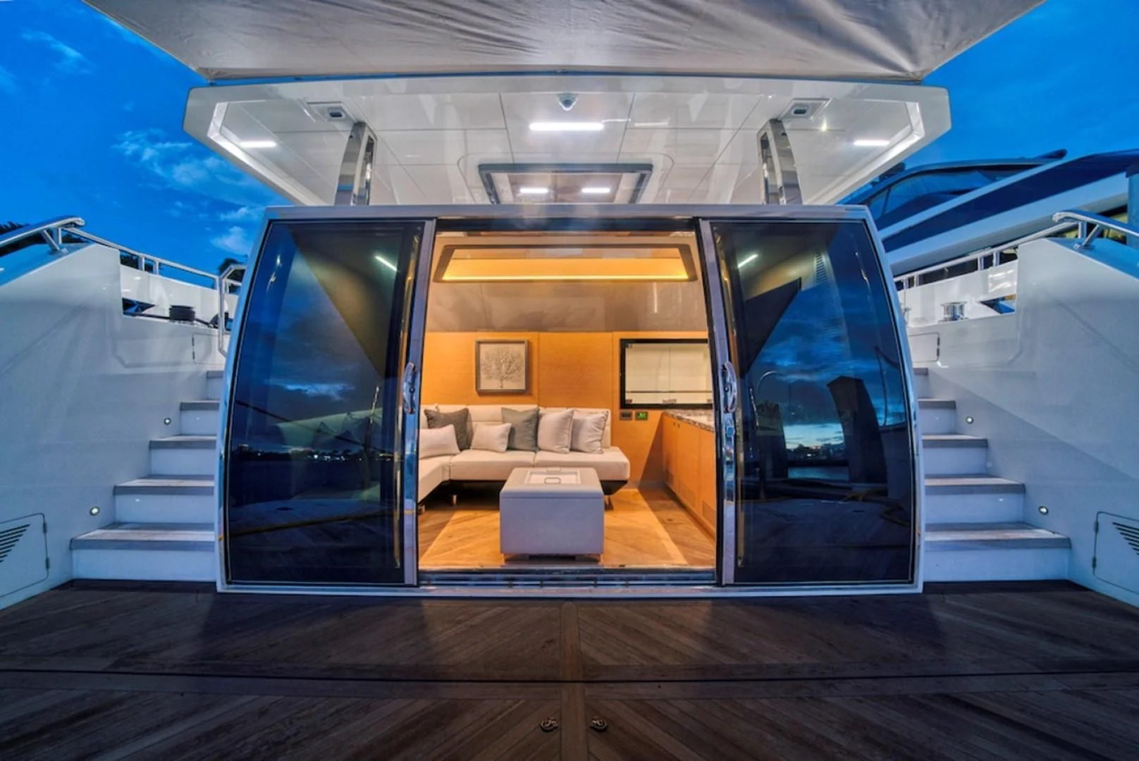 a room with a couch and a large glass door aboard SEASUITE Yacht for Charter