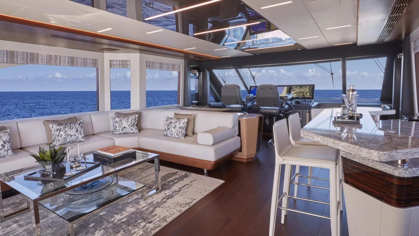a living room with a large window aboard SEASUITE Yacht for Charter