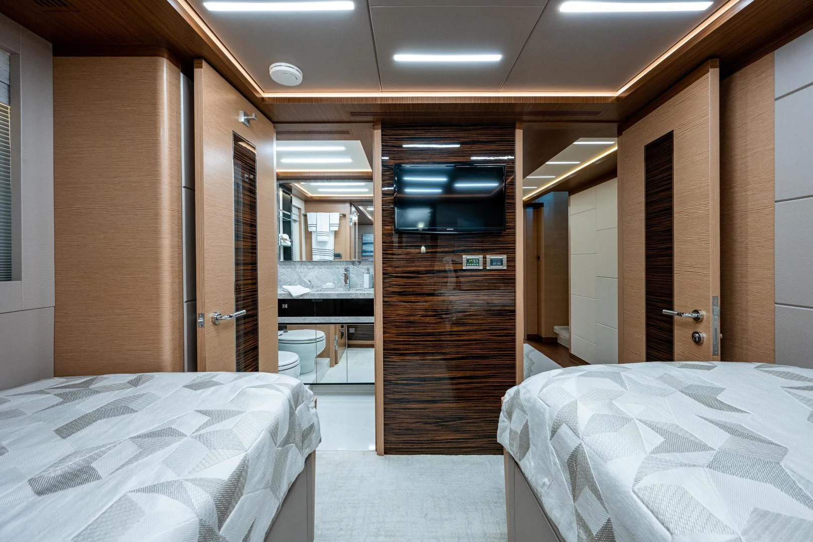 a room with a bed and a door aboard SEASUITE Yacht for Charter