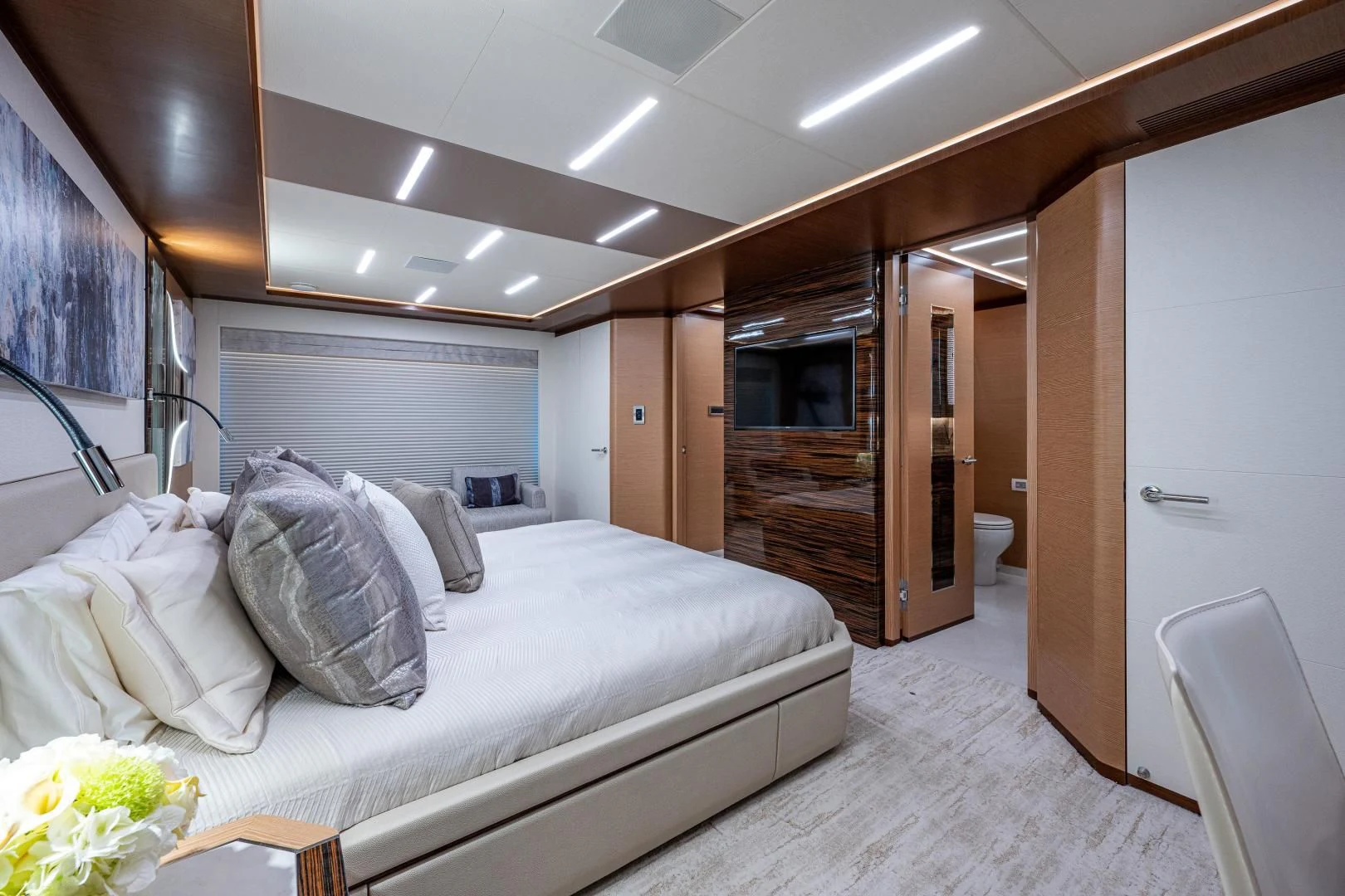 a bedroom with a bed and a fireplace aboard SEASUITE Yacht for Charter